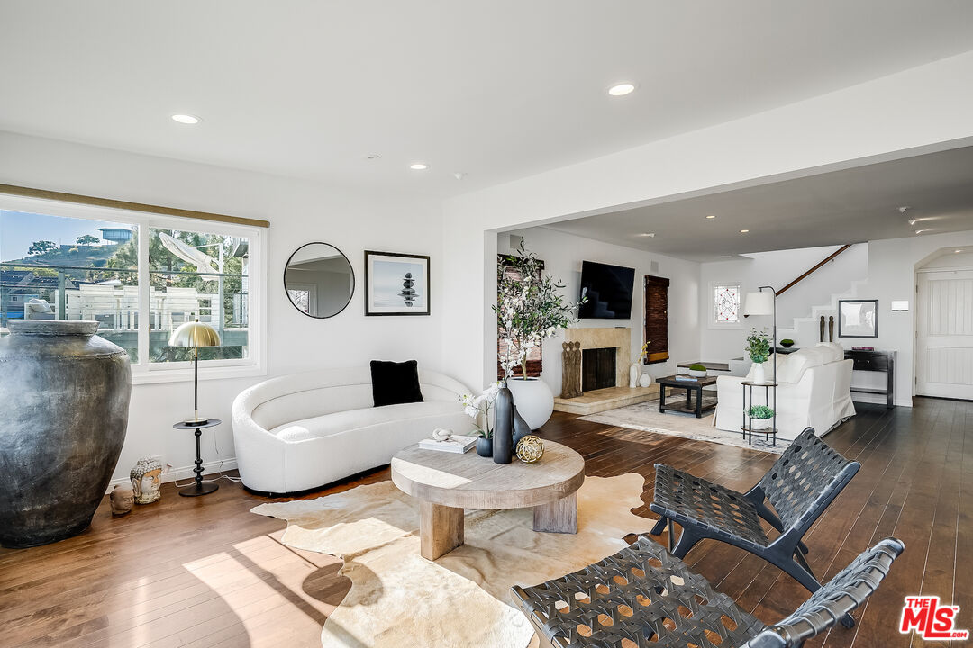 8912 Appian Way Los Angeles, CA 90046 - Photo 11 of 55 a living room with fireplace furniture and a large window