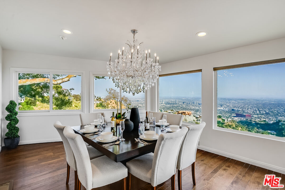 8912 Appian Way Los Angeles, CA 90046 - Photo 14 of 55 a dining room with furniture a large window and wooden floor