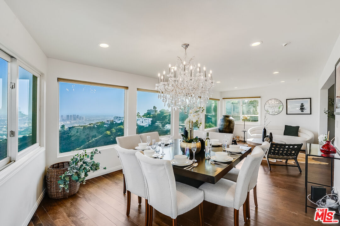 8912 Appian Way Los Angeles, CA 90046 - Photo 15 of 55 a view of a dining room with furniture window and wooden floor