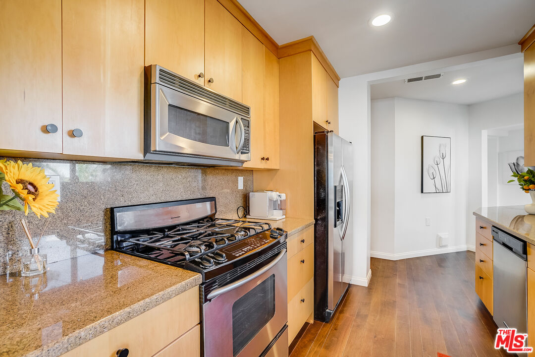 8912 Appian Way Los Angeles, CA 90046 - Photo 17 of 55 a kitchen with stainless steel appliances granite countertop a stove and a microwave