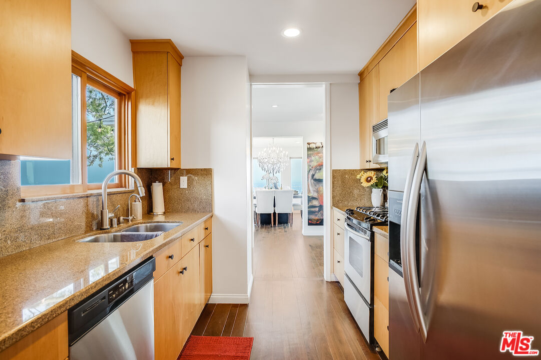 8912 Appian Way Los Angeles, CA 90046 - Photo 18 of 55 a kitchen with stainless steel appliances a sink a stove and a refrigerator