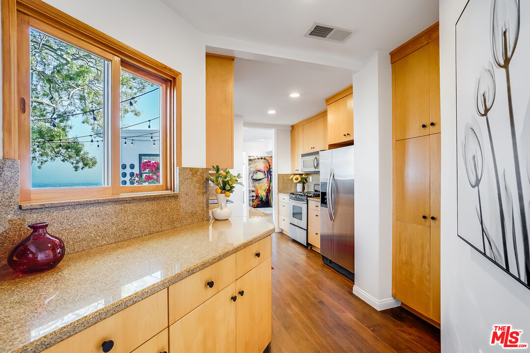 8912 Appian Way Los Angeles, CA 90046 - Photo 19 of 55 a kitchen with stainless steel appliances a refrigerator and a sink