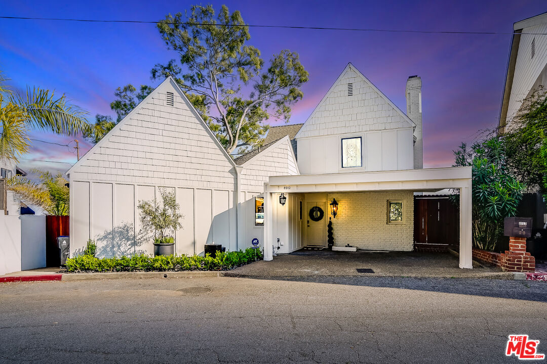 8912 Appian Way Los Angeles, CA 90046 - Photo 2 of 55 a front view of a house with a yard and garage