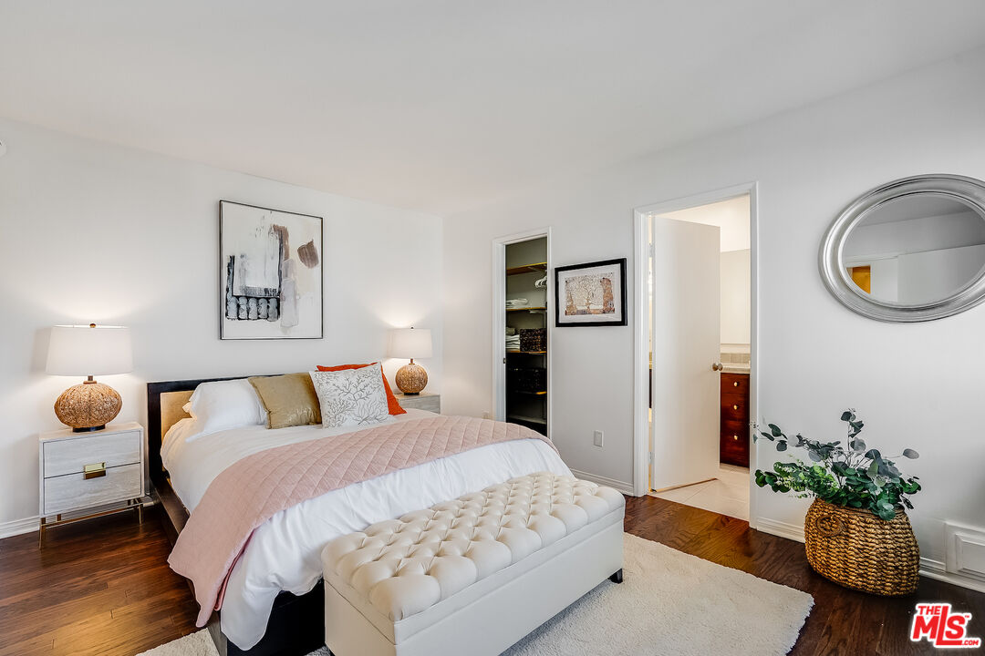 8912 Appian Way Los Angeles, CA 90046 - Photo 23 of 55 a bed room with a bed and a potted plant