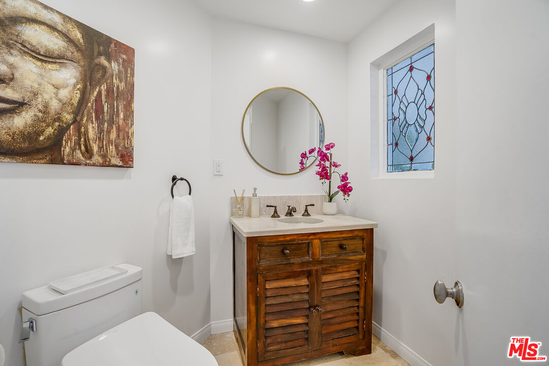 8912 Appian Way Los Angeles, CA 90046 - Photo 27 of 55 a bathroom with a toilet a sink and a mirror