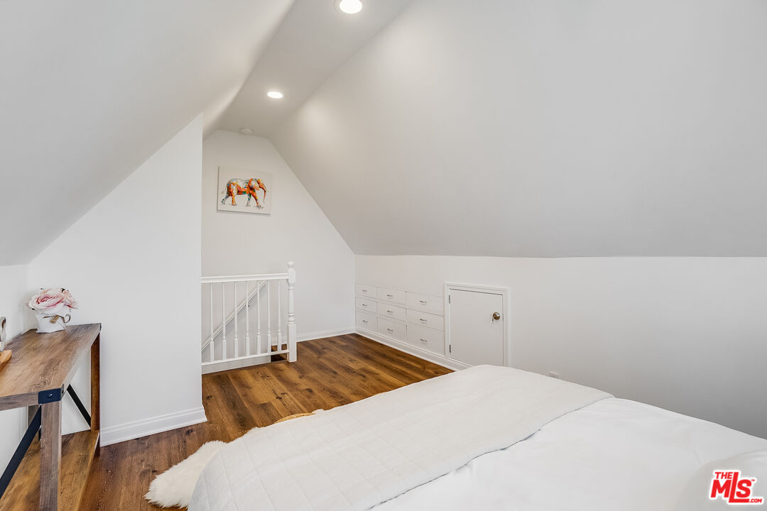 8912 Appian Way Los Angeles, CA 90046 - Photo 31 of 55 a bedroom with a bed and a chair