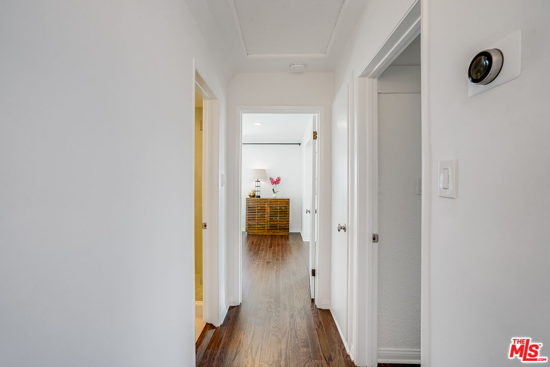 8912 Appian Way Los Angeles, CA 90046 - Photo 34 of 55 a walk in closet with wooden floor