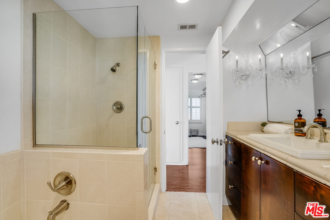 8912 Appian Way Los Angeles, CA 90046 - Photo 38 of 55 a bathroom with a sink shower and a mirror