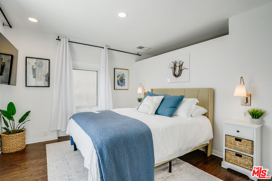 8912 Appian Way Los Angeles, CA 90046 - Photo 42 of 55 a bedroom with a bed and a potted plant on the dresser
