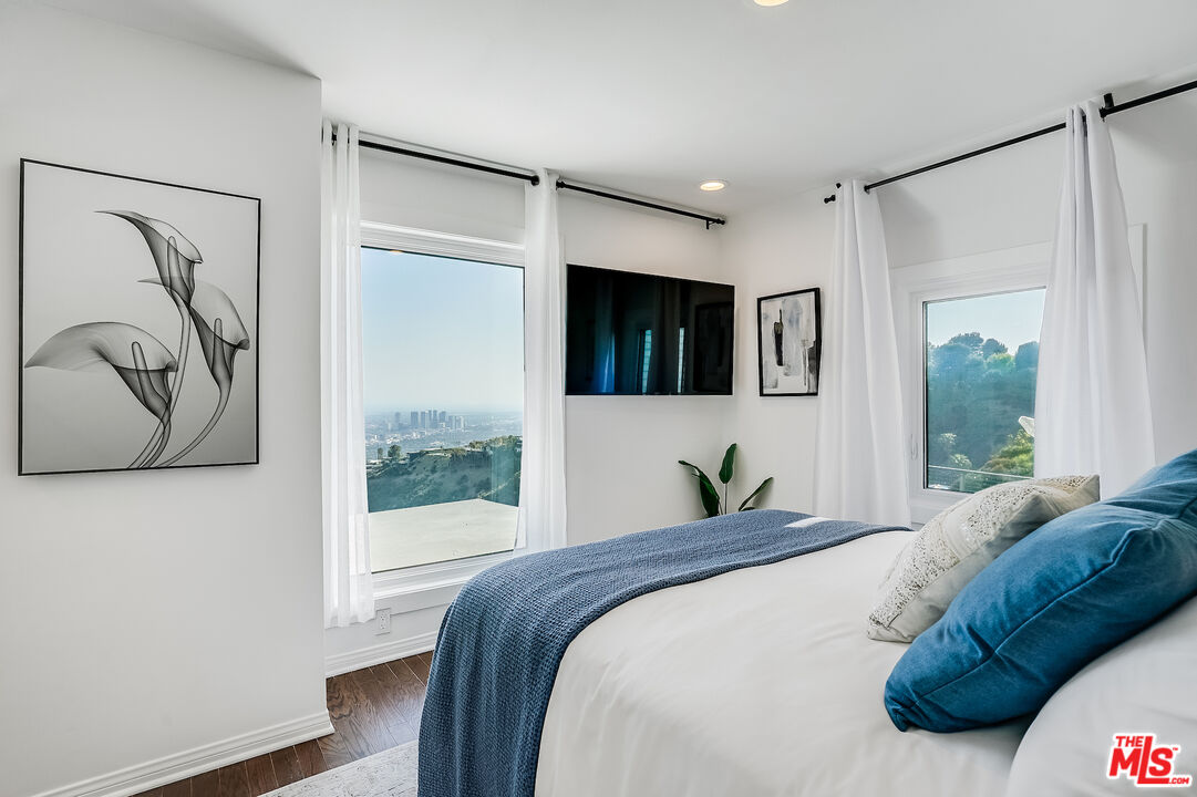 8912 Appian Way Los Angeles, CA 90046 - Photo 43 of 55 a bedroom with a large bed and a window