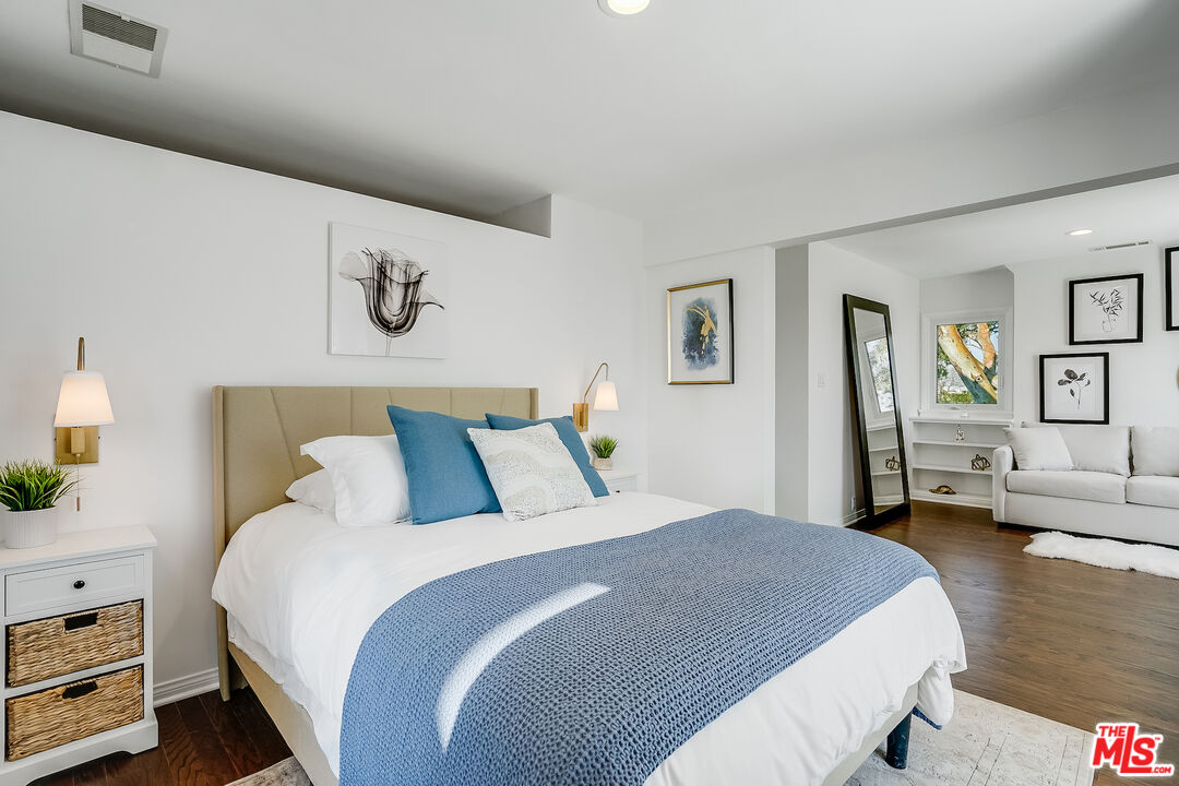 8912 Appian Way Los Angeles, CA 90046 - Photo 44 of 55 a bedroom with a bed and wooden floor