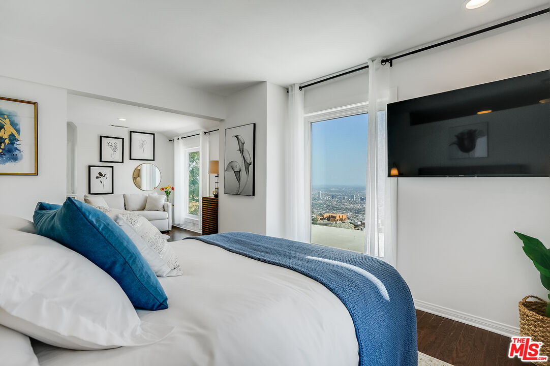 8912 Appian Way Los Angeles, CA 90046 - Photo 45 of 55 a bedroom with a bed and a television