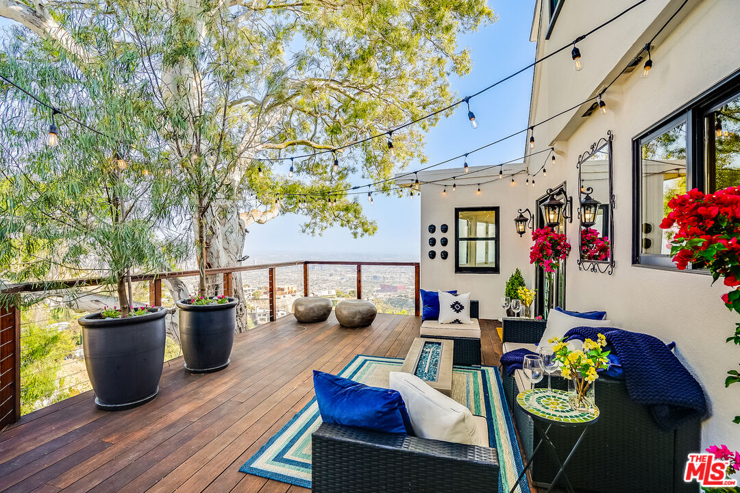 8912 Appian Way Los Angeles, CA 90046 - Photo 48 of 55 a outdoor living space with furniture and wooden floor