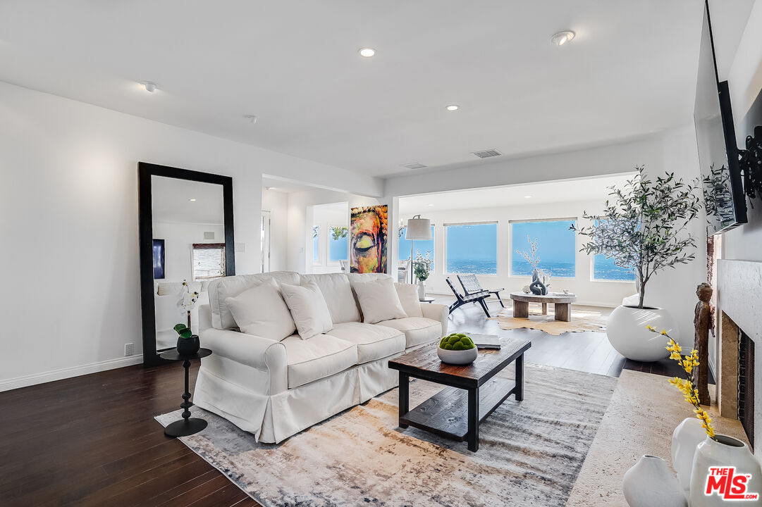 8912 Appian Way Los Angeles, CA 90046 - Photo 5 of 55 a living room with furniture and a flat screen tv