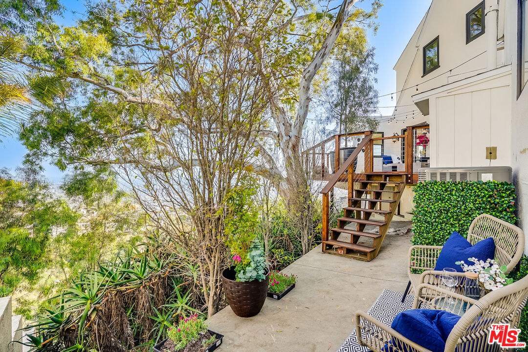 8912 Appian Way Los Angeles, CA 90046 - Photo 52 of 55 a view of a patio with couches and potted plants