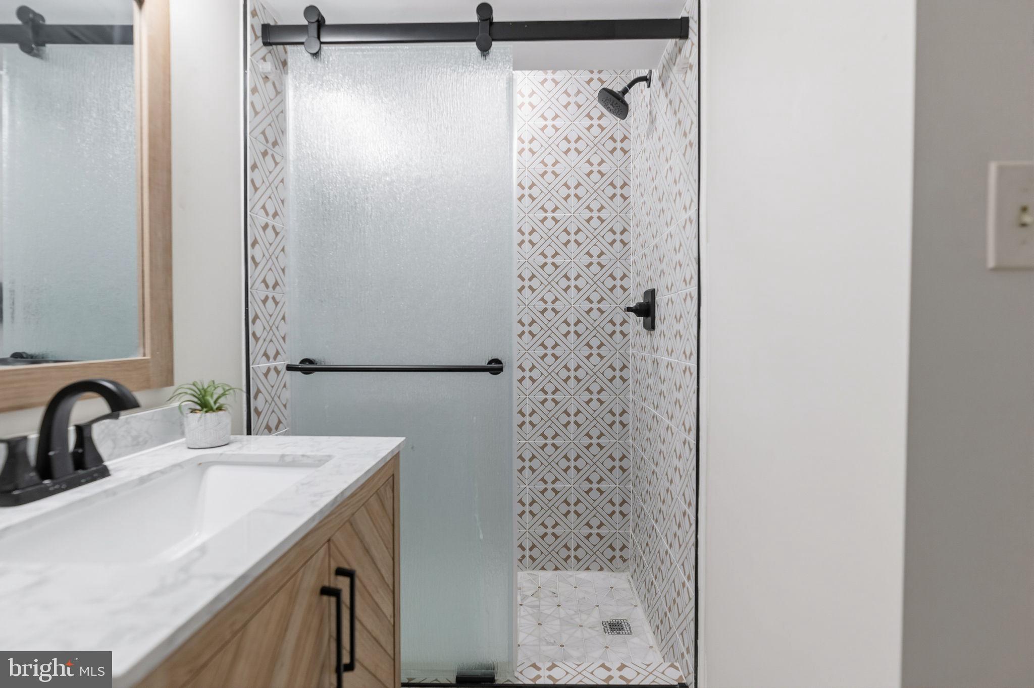 7603 Modisto Lane Springfield, VA 22153 - Photo 43 of 57 a bathroom with a sink and a mirror
