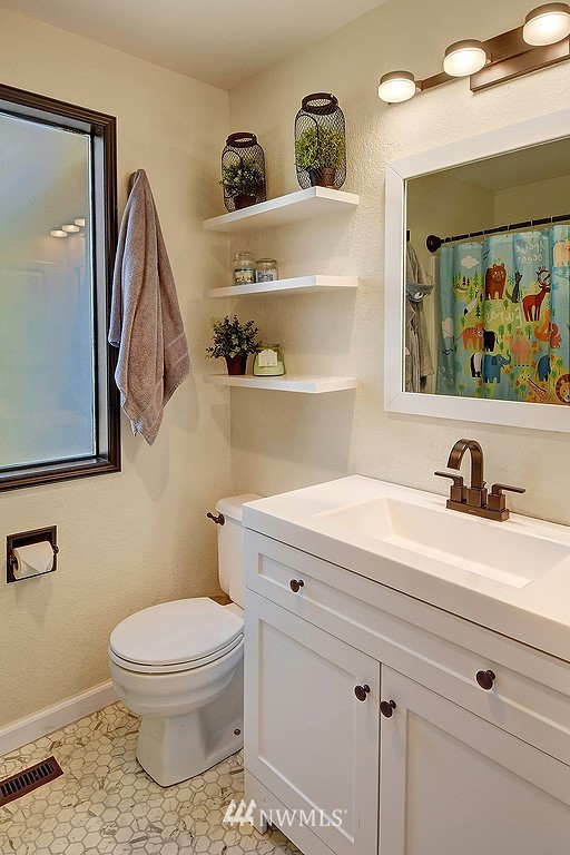 2514 243rd Place Southeast Bothell, WA 98021 - Photo 22 of 34 a bathroom with a toilet a sink and glass door