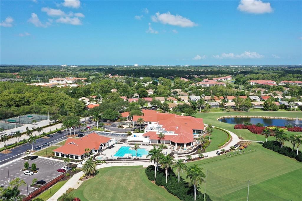 209 Countryside Drive Naples, FL 34104 - Photo 33 of 50 Aerial view of property and surrounding area featuring a nearby body of water and a golf club