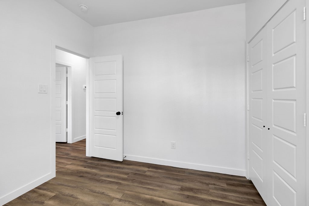 104 Runnels Street Willis, TX 77378 - Photo 16 of 27 a view of an empty room with wooden floor