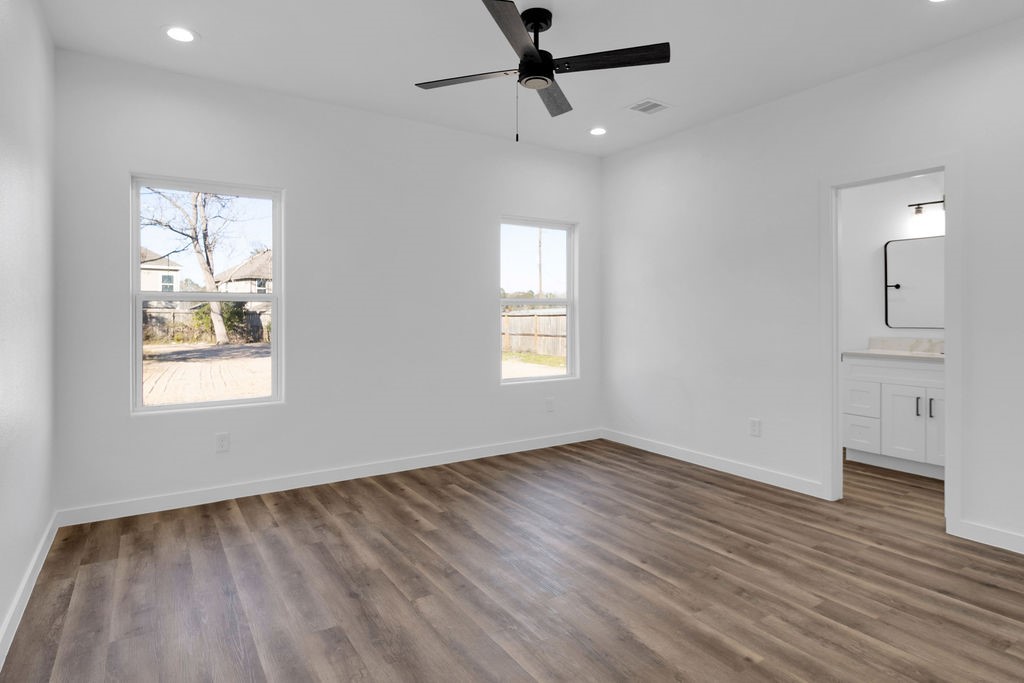 104 Runnels Street Willis, TX 77378 - Photo 20 of 27 wooden floor in an empty room with a window