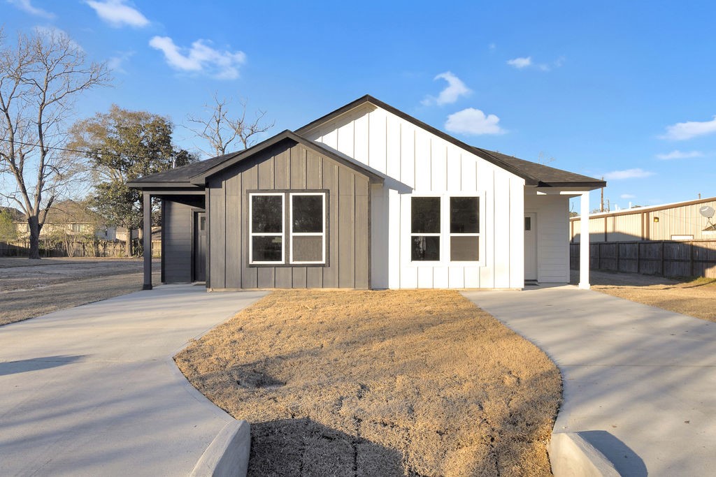 104 Runnels Street Willis, TX 77378 - Photo 2 of 27 a front view of a house with a yard