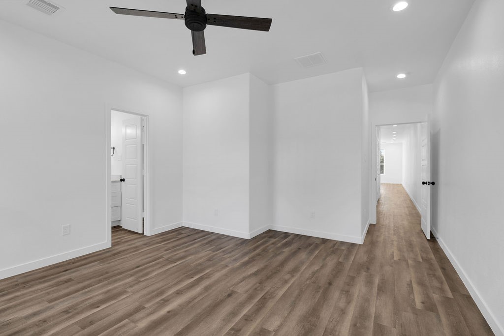 104 Runnels Street Willis, TX 77378 - Photo 21 of 27 a view of a room with wooden floor and white walls