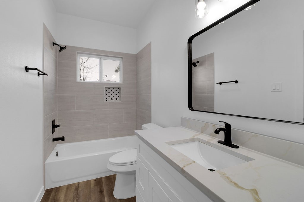 104 Runnels Street Willis, TX 77378 - Photo 23 of 27 a bathroom with a sink a toilet and shower
