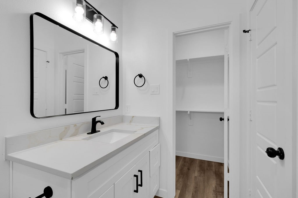 104 Runnels Street Willis, TX 77378 - Photo 24 of 27 a bathroom with a sink vanity and mirror
