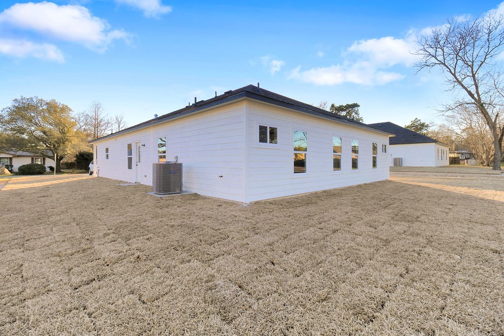 104 Runnels Street Willis, TX 77378 - Photo 27 of 27 a view of a backyard with a large tree
