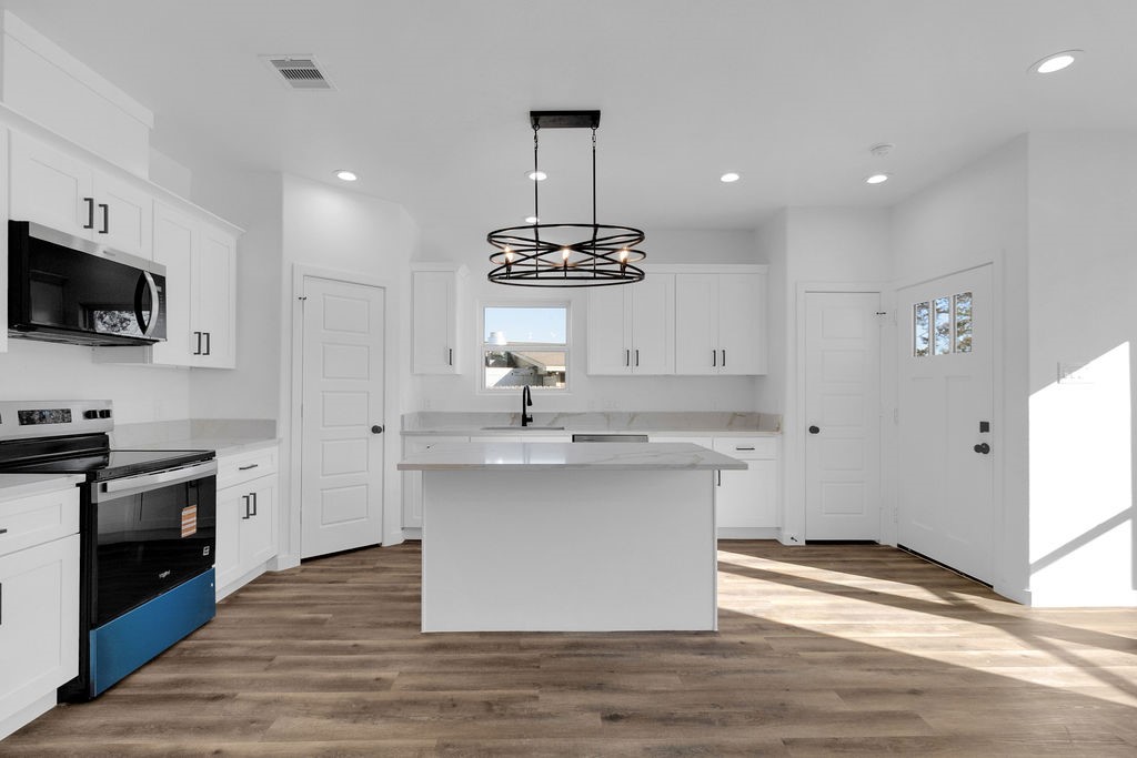 104 Runnels Street Willis, TX 77378 - Photo 5 of 27 a kitchen with a sink stainless steel appliances and cabinets