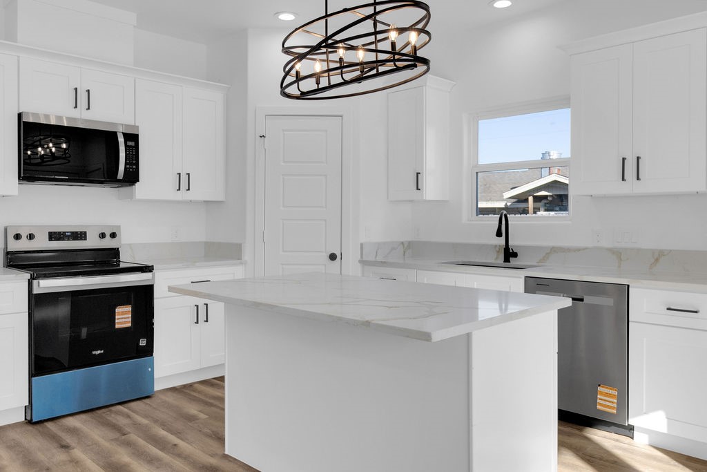 104 Runnels Street Willis, TX 77378 - Photo 6 of 27 a kitchen with a sink a stove and cabinets