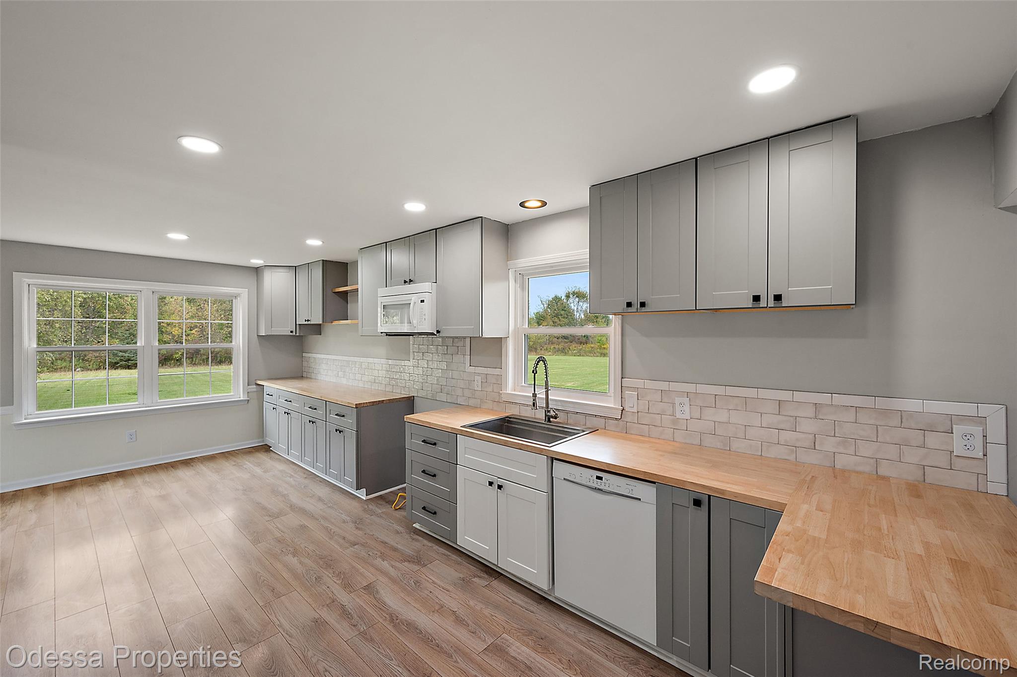 1442 Riley Center Road Memphis, MI 48041 - Photo 7 of 62 Kitchen featuring gray cabinets, backsplash, white appliances, recessed lighting, and light wood-type flooring