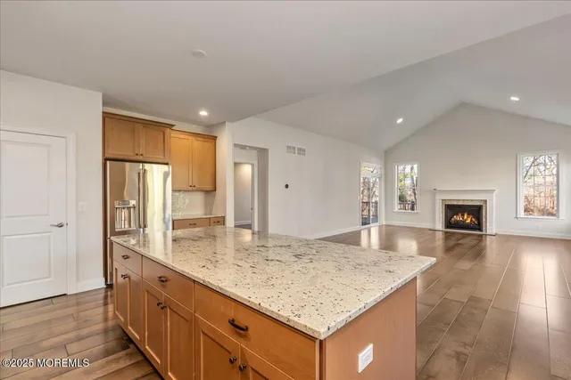 a kitchen with kitchen island granite countertop counter top space a sink appliances and cabinets