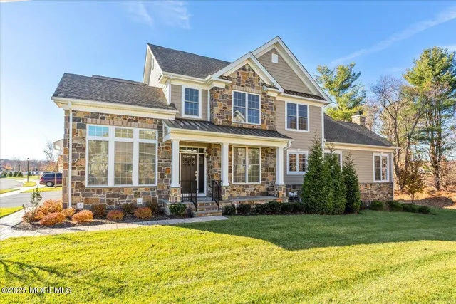 a front view of a house with a yard table and chairs