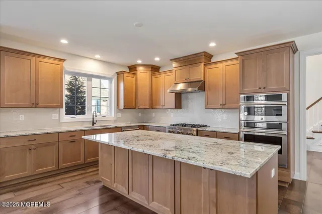 a kitchen with a sink stove and cabinets