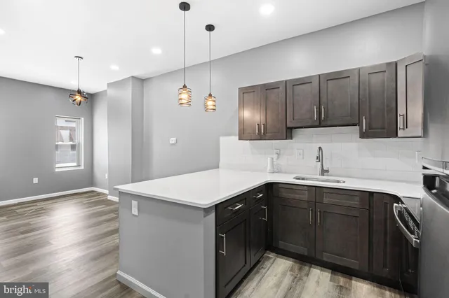 a kitchen with a sink a stove and cabinets