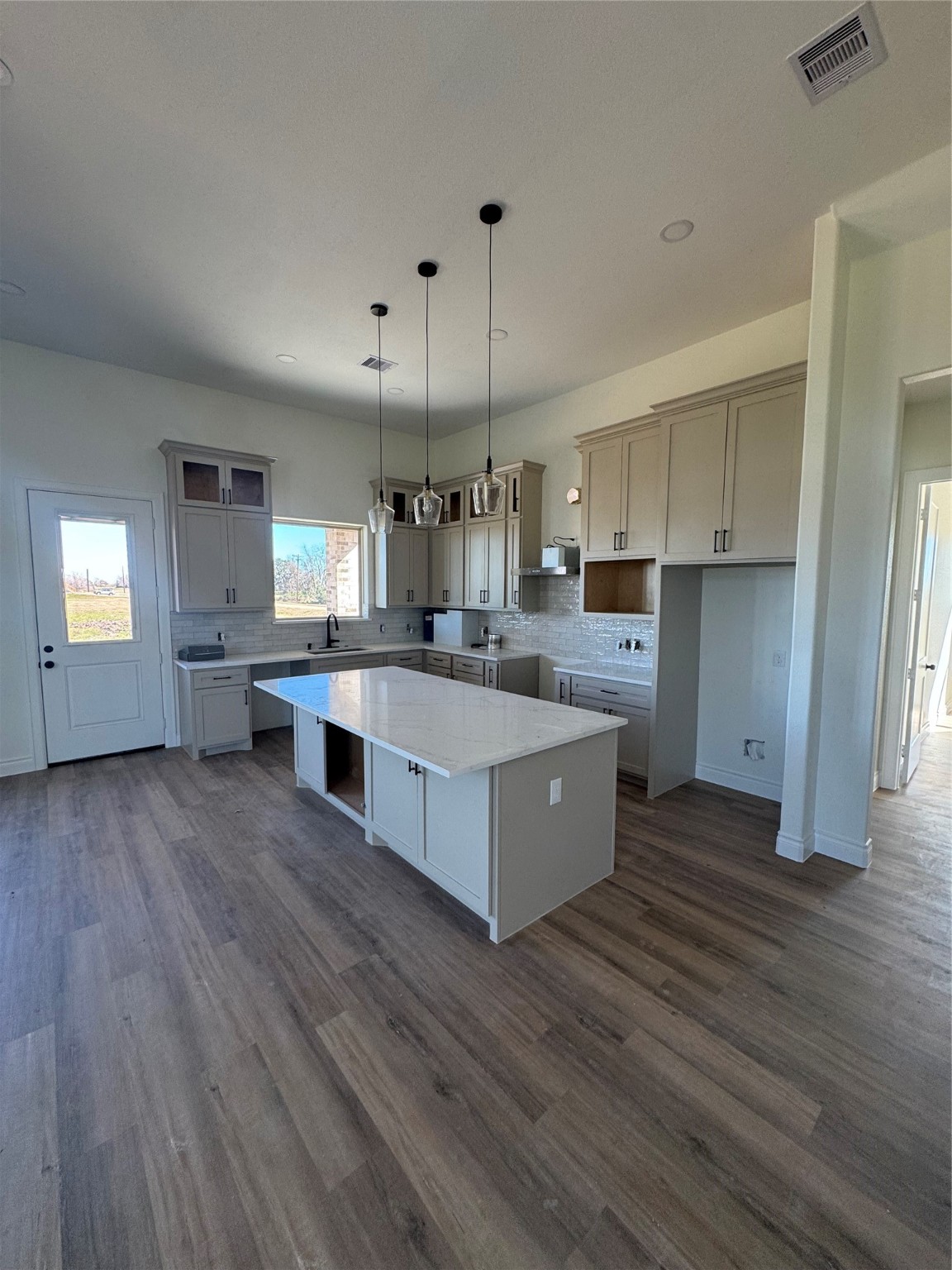 749 Wagon Wheel Trail Angleton, TX 77515 - Photo 2 of 9 a large kitchen with stainless steel appliances granite countertop a lot of counter space and wooden floors