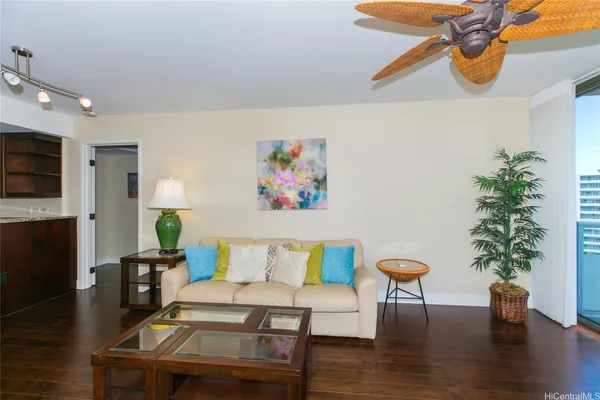 a living room with furniture and a potted plant