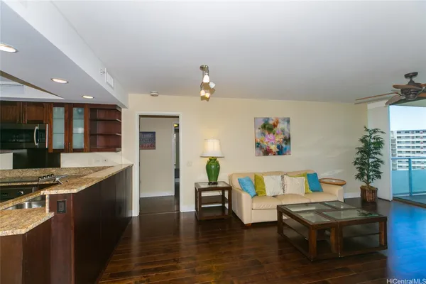 a living room with kitchen island furniture and a kitchen view