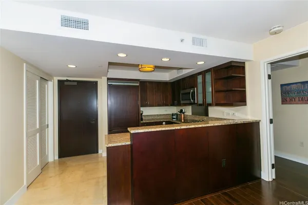 a kitchen with stainless steel appliances granite countertop a sink a stove and refrigerator