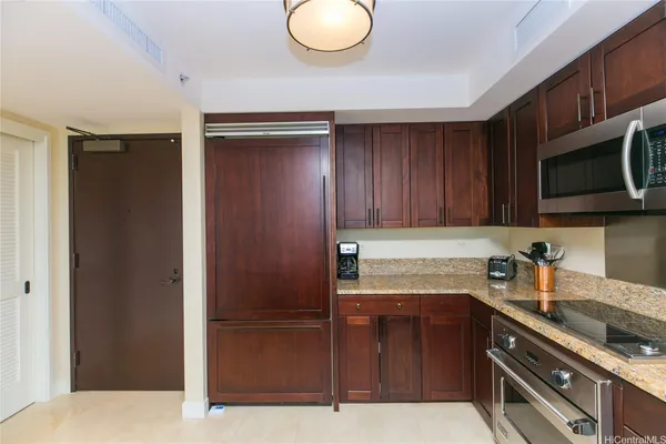 a kitchen with stainless steel appliances granite countertop a refrigerator and a sink