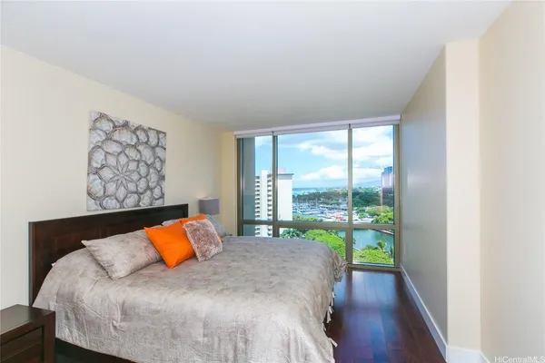 a bedroom with a bed and lamp