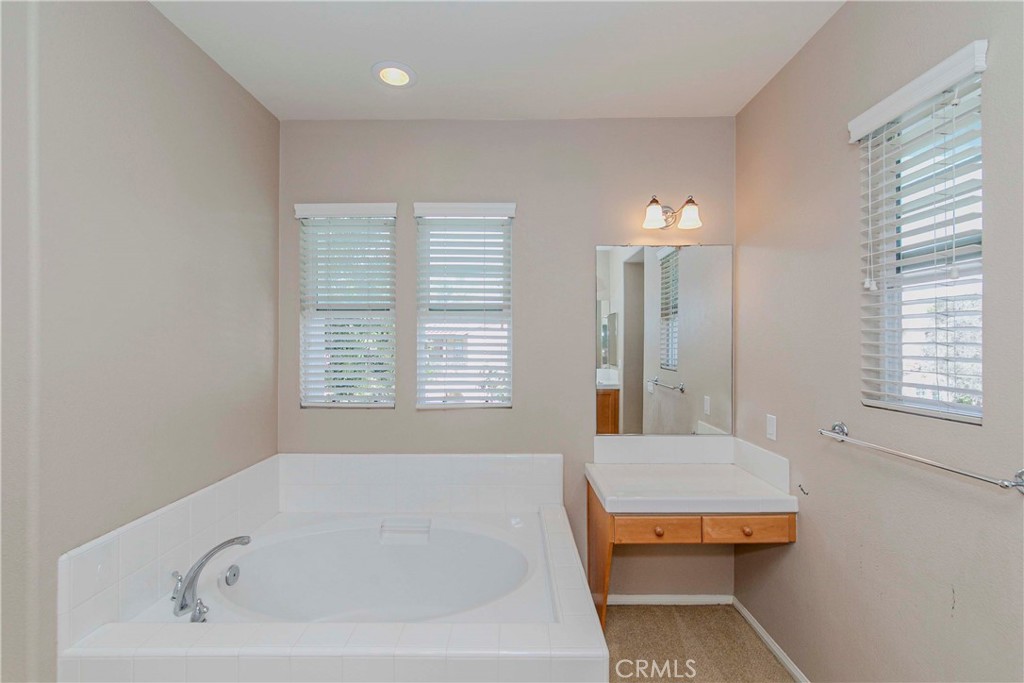 67 Canopy Irvine, CA 92603 - Photo 21 of 47 a bathroom with a bathtub and window