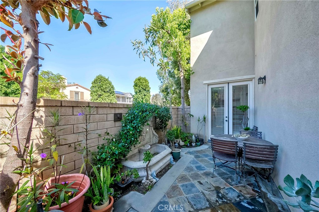 67 Canopy Irvine, CA 92603 - Photo 34 of 47 a backyard of a house with wooden floor and outdoor seating