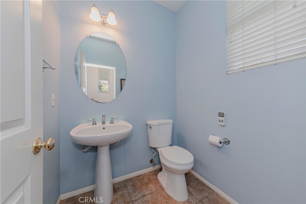 67 Canopy Irvine, CA 92603 - Photo 5 of 47 a bathroom with a sink a mirror and a toilet