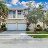 a front view of a house with a yard and a garage