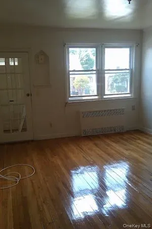 a view of a room with wooden floor and windows