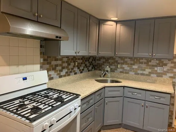 a kitchen with sink cabinets and stove