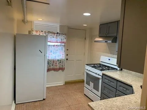 a kitchen with a stove and a refrigerator