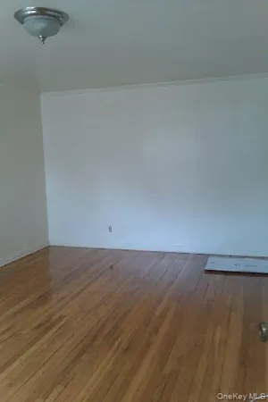 a view of an empty room and wooden floor